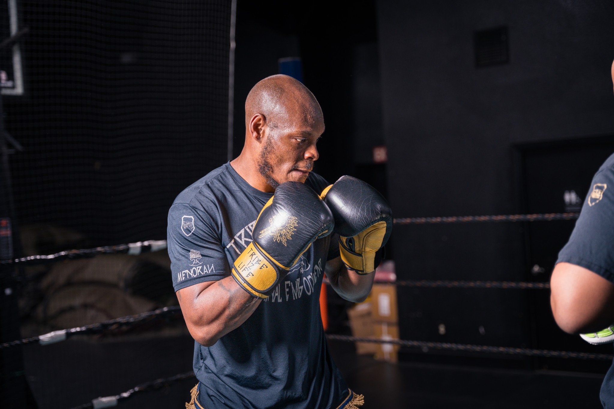 A competitive track member executing high guard defense during sparring drills