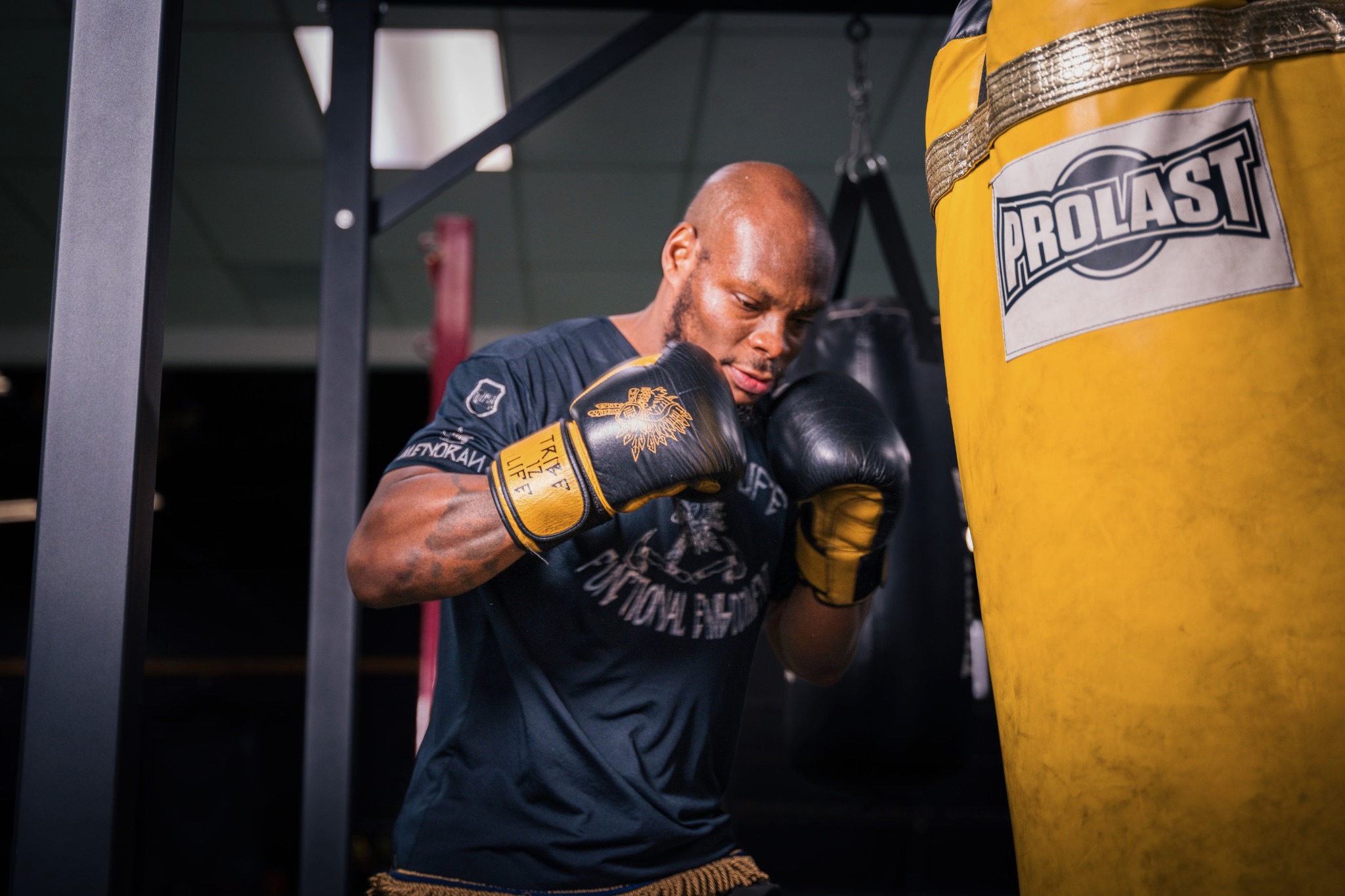 Black-veteran owned Fit4Battle Boxing gym interior layout with heavy bags and training ring